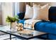 Close up on the details of the living room, including the dark wooden floors and the blue couch at 774 Chelsea Dr, Davenport, FL 33897