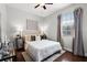 Cozy bedroom featuring ceiling fan, a comfortable bed and ample natural light at 774 Chelsea Dr, Davenport, FL 33897