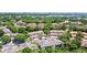 Aerial view of a community with lush greenery, tile roofs, and scenic surroundings at 7768 Sugar Bend Dr # 7768, Orlando, FL 32819