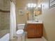 Bright bathroom featuring a shower-tub combo and decorative mirror at 7768 Sugar Bend Dr # 7768, Orlando, FL 32819