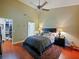 Cozy bedroom featuring wood floors, ceiling fan, and walk-in closet at 7768 Sugar Bend Dr # 7768, Orlando, FL 32819