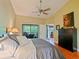 Comfortable bedroom with ceiling fan, balcony, and dark wood dresser at 7768 Sugar Bend Dr # 7768, Orlando, FL 32819