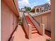 The exterior features a staircase leading to the apartments, and doors to the adjacent apartments at 7768 Sugar Bend Dr # 7768, Orlando, FL 32819