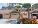 Inviting home exterior featuring a neutral color palette, tile roof, and attached garage at 7768 Sugar Bend Dr # 7768, Orlando, FL 32819