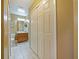 Hallway with closet leading to a bathroom with a single sink at 7768 Sugar Bend Dr # 7768, Orlando, FL 32819
