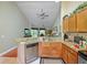 Open concept kitchen featuring granite countertops and stainless steel dishwasher at 7768 Sugar Bend Dr # 7768, Orlando, FL 32819