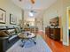 Open-concept living room featuring dark sofa, and kitchen access at 7768 Sugar Bend Dr # 7768, Orlando, FL 32819