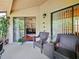 Charming screened patio with seating, plants, and view to inside at 7768 Sugar Bend Dr # 7768, Orlando, FL 32819