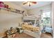 Bright bedroom with a bunk bed and decorated shelves at 7819 Hardenton St, Windermere, FL 34786