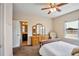 Spacious bedroom featuring natural light, a vanity, and connecting bathroom at 7819 Hardenton St, Windermere, FL 34786