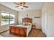 Bedroom featuring a decorative wood bed frame, side tables and large windows at 7819 Hardenton St, Windermere, FL 34786