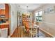 Bright dining room featuring a wooden table set, a bookshelf, and natural light streaming through a window at 7819 Hardenton St, Windermere, FL 34786