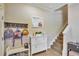 Inviting foyer with staircase, mirror, and storage, with hooks and shoe rack adding a practical touch to the home's entrance at 7819 Hardenton St, Windermere, FL 34786