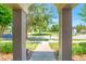 View of open green space through the covered front entry at 7819 Hardenton St, Windermere, FL 34786