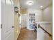 Bright hallway with an alcove featuring a bookshelf and piano at 7819 Hardenton St, Windermere, FL 34786