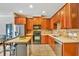 Beautiful kitchen featuring wooden cabinetry, stainless steel appliances, and a convenient island workstation for cooking at 7819 Hardenton St, Windermere, FL 34786