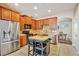 Modern kitchen featuring stainless steel appliances, an island workstation, and easy access to the dining area at 7819 Hardenton St, Windermere, FL 34786