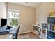 Home office featuring a desk, chair, and shelving unit with natural light at 7819 Hardenton St, Windermere, FL 34786