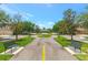 Beautiful tree lined street with benches and walkway in a residential community with blue skies in the background at 7819 Hardenton St, Windermere, FL 34786