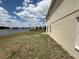 Lake view from the backyard with adjacent home exterior at 786 Crystal Bay Ln, Orlando, FL 32828