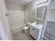 Clean bathroom with tub, shower, and white vanity with updated sink and mirror at 786 Crystal Bay Ln, Orlando, FL 32828