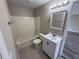 Cozy bathroom with a shower-tub combo, vanity, mirror, and neutral colors at 786 Crystal Bay Ln, Orlando, FL 32828