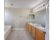 Bathroom with dual sinks, granite countertops, and wood cabinets at 786 Crystal Bay Ln, Orlando, FL 32828