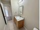 A bathroom featuring a granite vanity, tiled floor, updated fixtures, and neutral decor at 786 Crystal Bay Ln, Orlando, FL 32828