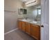 Bathroom featuring double sinks, granite countertop, large vanity mirror, and cabinets at 786 Crystal Bay Ln, Orlando, FL 32828