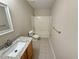 A bathroom featuring a granite vanity, tiled floor, and tub and shower at 786 Crystal Bay Ln, Orlando, FL 32828