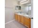 Bathroom with dual sinks, granite countertops, and wood cabinets at 786 Crystal Bay Ln, Orlando, FL 32828