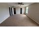 Bedroom with wall-to-wall carpet, neutral paint, ceiling fan, and closet entrances at 786 Crystal Bay Ln, Orlando, FL 32828