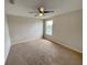 Bedroom with a ceiling fan, carpeted floor, and a window bringing in natural light at 786 Crystal Bay Ln, Orlando, FL 32828