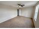 Spacious bedroom featuring neutral walls, brown carpet, and a ceiling fan at 786 Crystal Bay Ln, Orlando, FL 32828