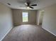 Bright bedroom with carpet flooring, ceiling fan, and a sunlit window at 786 Crystal Bay Ln, Orlando, FL 32828