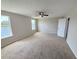 Bedroom with carpet, neutral walls, ceiling fan, and views of the pond at 786 Crystal Bay Ln, Orlando, FL 32828