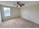 Bright bedroom with a ceiling fan, carpeted floor, and a window bringing in natural light at 786 Crystal Bay Ln, Orlando, FL 32828