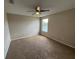 Neutral bedroom featuring a ceiling fan, carpeted floors, and a window offering a peaceful view at 786 Crystal Bay Ln, Orlando, FL 32828