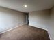 An empty bedroom with beige carpet and neutral-colored walls, ready for personalization at 786 Crystal Bay Ln, Orlando, FL 32828