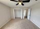 Bedroom featuring neutral walls, carpet, and doors to closet and entry at 786 Crystal Bay Ln, Orlando, FL 32828