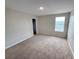 Bedroom featuring neutral walls, carpet, and natural light from a window at 786 Crystal Bay Ln, Orlando, FL 32828
