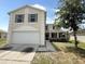 Two-story home featuring a two-car garage, lawn, and neutral paint at 786 Crystal Bay Ln, Orlando, FL 32828