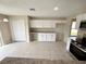 Kitchen with white cabinets, stainless steel appliances, tile floor, and granite countertops at 786 Crystal Bay Ln, Orlando, FL 32828