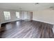 Spacious living room featuring wood floors, neutral walls, and natural light from two large windows at 786 Crystal Bay Ln, Orlando, FL 32828