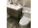 Bathroom showcasing modern sink with wood cabinets and fixtures, and a white toilet at 8973 Lee Vista Blvd # 2308, Orlando, FL 32829