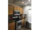 Modern kitchen showcasing stainless steel appliances, warm wood cabinetry, and stylish countertops at 8973 Lee Vista Blvd # 2308, Orlando, FL 32829