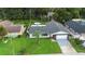 Home with a well-kept lawn, paved driveway, and a backyard featuring an above-ground pool at 10140 Bridlewood Ave, Orlando, FL 32825