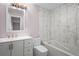 This bathroom features marble tile, a tub, toilet, modern vanity and sink with gold fixtures at 10140 Bridlewood Ave, Orlando, FL 32825