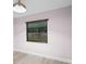 This room features wood-look floors, blinds on the window, and a modern light fixture at 10140 Bridlewood Ave, Orlando, FL 32825