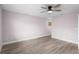 A spacious room with wood-look flooring and a ceiling fan at 10140 Bridlewood Ave, Orlando, FL 32825
